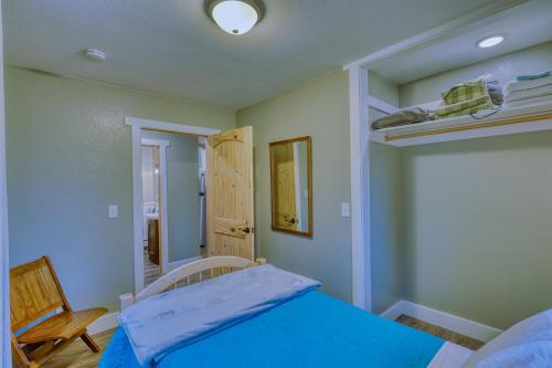 a bedroom with a blue bed and a bunk room at Captivating Coastline 2 BR Retreat with Ocean View in Kodiak