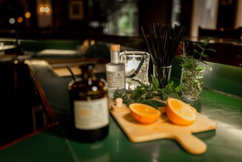 a bottle of wine and two orange slices on a table at Hotel Spahr in Stuttgart