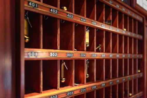a wooden shelf filled with lots of wine bottles at Hotel Spahr in Stuttgart