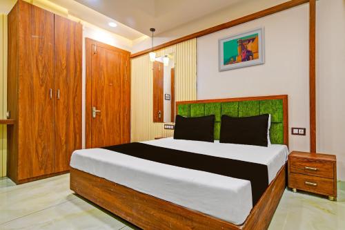 a bedroom with a large bed and wooden cabinets at OYO Hotel Shree in Dewās