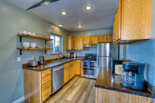 a kitchen with wooden cabinets and stainless steel appliances at Rustic Retreat Charming 2 Bedroom Apt Sleeps 4 in Kodiak