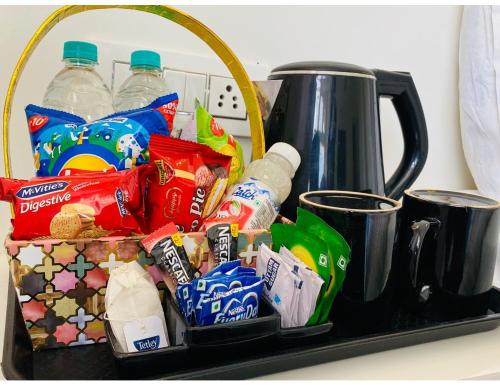 a tray filled with snacks and drinks on a counter at Hotel Diamond, Mussoorie in Mussoorie