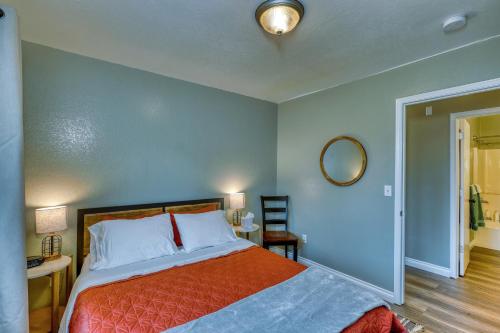 a bedroom with a bed and a mirror on the wall at Rustic Retreat Charming 2 Bedroom Apt Sleeps 4 in Kodiak