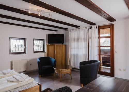 a bedroom with a bed and a table and chairs at Trobischhof in Dresden