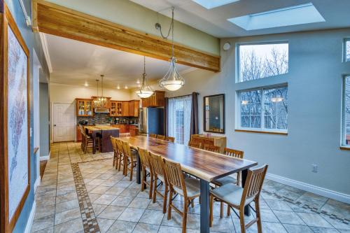 a kitchen and dining room with a large wooden table and chairs at Lodge Style Living Spacious 5BR Reunion Getaway in Kodiak