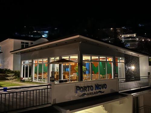 a restaurant with a lot of windows at night at Porto Novo Anilao Dive and Leisure Resort in Mabini