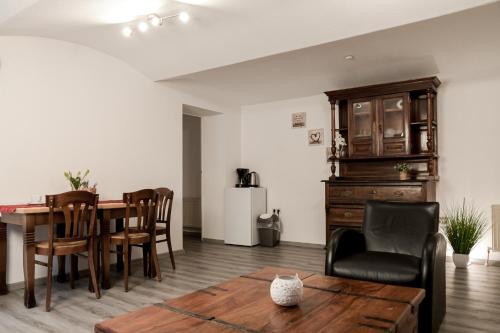a living room with a dining room table and chairs at Trobischhof in Dresden