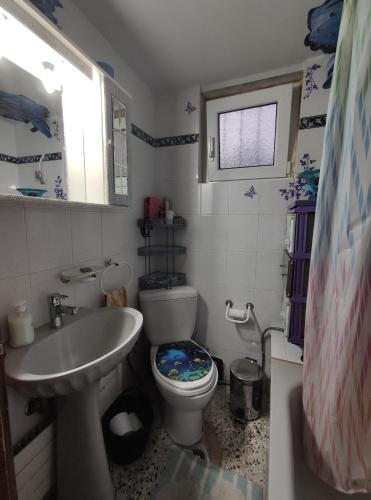 a small bathroom with a toilet and a sink at Kalys House in Kavála