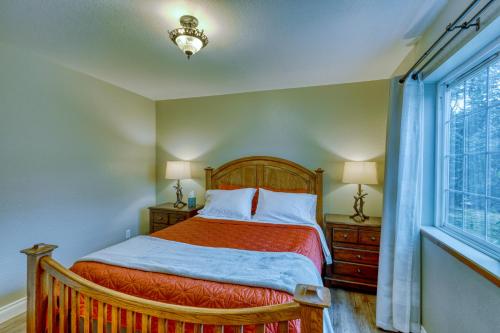 a bedroom with a bed and a window at Rustic Elegance 7 Bedrms 4 bath Cathedral Ceilings in Kodiak
