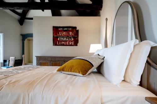 a bedroom with a large bed with white pillows at Palazzo Boyl 1840 in Cagliari