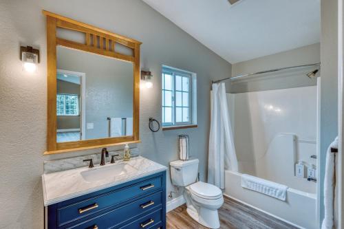 a bathroom with a sink and a toilet and a mirror at Rustic Elegance 7 Bedrms 4 bath Cathedral Ceilings in Kodiak