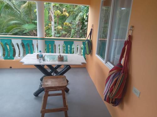 a bathroom with a sink in a room with a window at Port Antonio Brian's Beach House in Port Antonio
