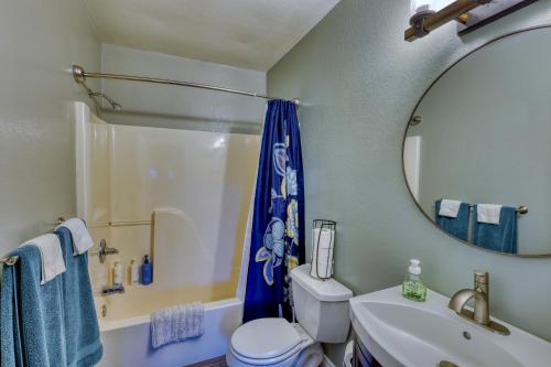 a bathroom with a toilet and a sink and a mirror at Rustic Elegance 7 Bedrms 4 bath Cathedral Ceilings in Kodiak