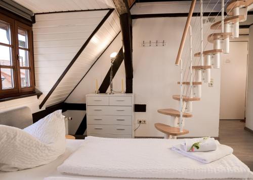 an attic bedroom with a bed and a staircase at Trobischhof in Dresden
