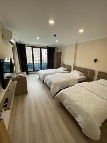 Ένα ή περισσότερα κρεβάτια σε δωμάτιο στο Rena Grand Residence & Suit