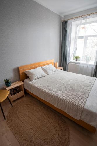 a bedroom with a large bed and a window at Nice&cozy flat No7 in Rīga
