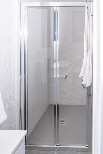 a shower with a glass door in a bathroom at Venus Apartment in Larnaca