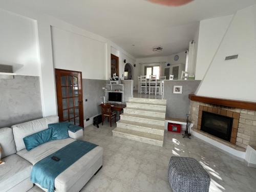 a living room with a couch and a fireplace at Villa Boa Vista Sul - Terra da Eira - Raposeira in Vila do Bispo
