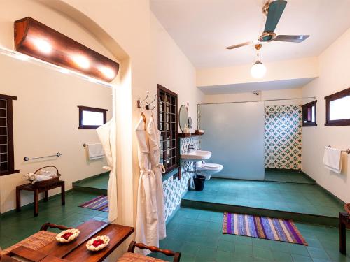 a bathroom with a shower and a toilet at The House of MG-A Heritage Hotel, Ahmedabad in Ahmedabad