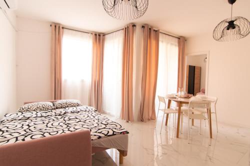 a bedroom with a bed and a table with chairs at S&B Apartment in Koper