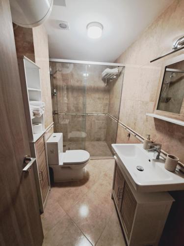 a bathroom with a shower and a toilet and a sink at Apartment Aphaya, complex Carpe Diem, Апартамент Афайя, комплекс Карпе Дием in Balchik