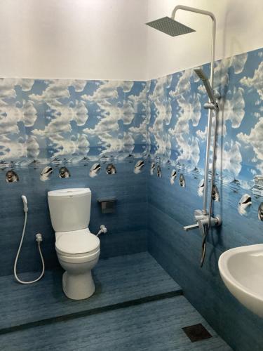 a bathroom with a toilet and a sink at Aroma Guest House in Mirissa
