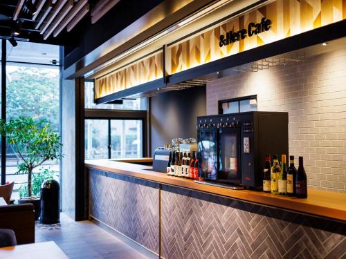 a bar in a restaurant with bottles of wine at &Here TOKYO UENO in Tokyo