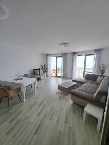 a living room with a couch and a table at Apartment Aphaya, complex Carpe Diem, Апартамент Афайя, комплекс Карпе Дием in Balchik