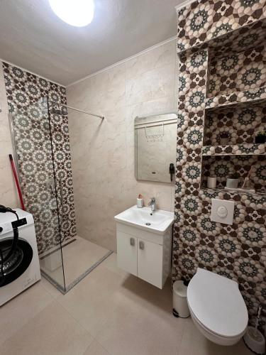 a bathroom with a toilet and a shower and a sink at Darius in Tuzla