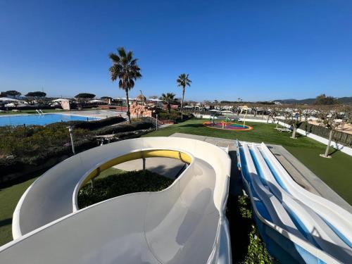 a slide at a water park with a playground at Camping Resort Els Pins in Malgrat de Mar