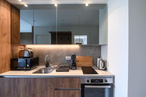 a kitchen with a sink and a stove top oven at Belgrade Waterfront Residences - Beograd na vodi in Belgrade