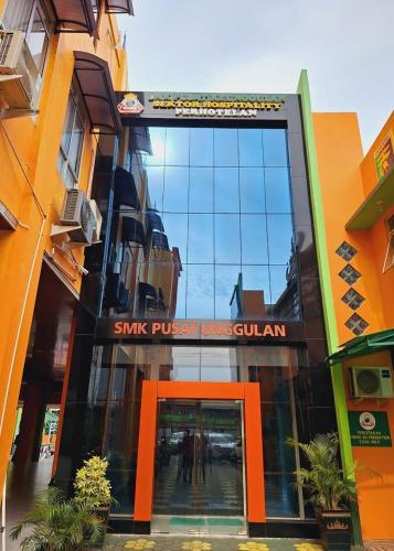 a building with a sign on the front of it at Great Cokro Edotel Lampung in Lampung