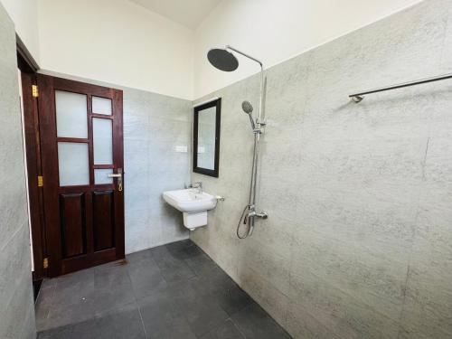 a bathroom with a sink and a toilet at Hikka Garden Villa in Hikkaduwa