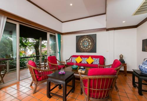 a living room with red chairs and a red couch at Katamanda villa Sooksan Near Kata Noi Beach in Kata Beach