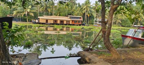 a train is parked next to a body of water at Waterlily Homestay in Kottayam