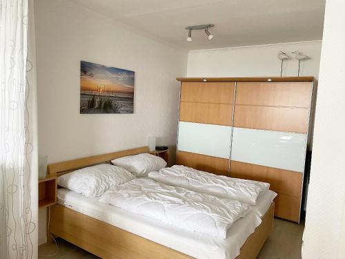 Un pat sau paturi într-o cameră la Vier Jahreszeiten 3-83