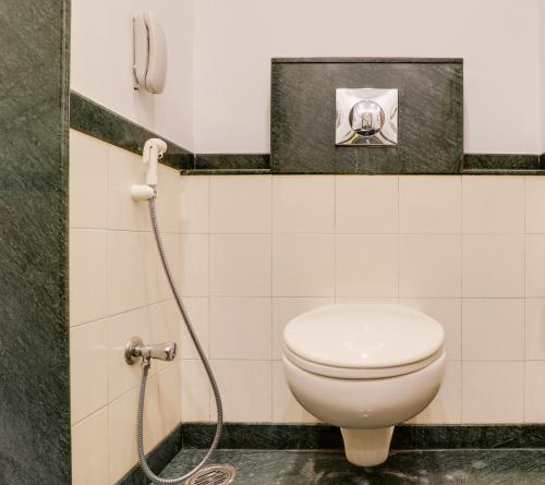 a bathroom with a toilet and a shower at Lemon Tree Hotel Chandigarh in Chandīgarh