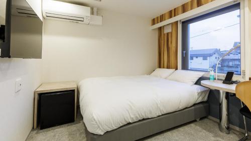 Cama o camas de una habitación en Tabist MEN‘TEL Kitami