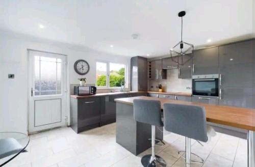 a kitchen with a counter and a clock on the wall at Woods view, central thornaby in Thornaby on Tees