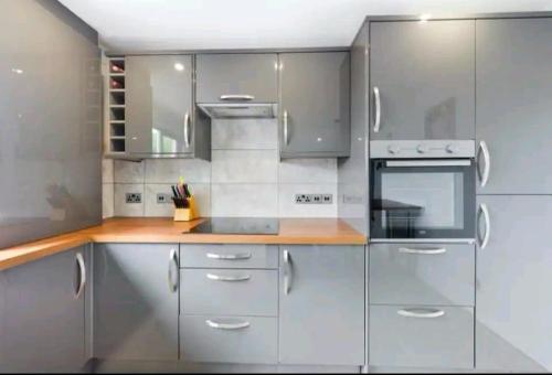 a kitchen with stainless steel appliances and wooden counters at Woods view, central thornaby in Thornaby on Tees
