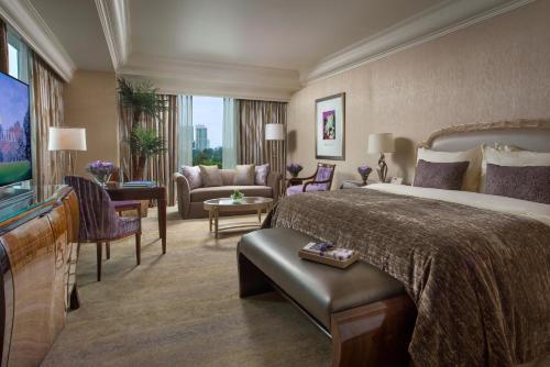 a hotel room with a large bed and a living room at Hotel Mulia Senayan, Jakarta in Jakarta