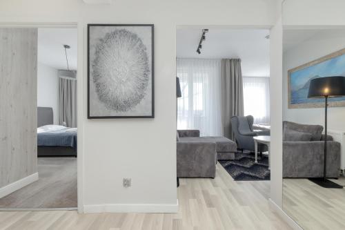 a living room with a couch and a table at Aparthotel Etna in Kołobrzeg