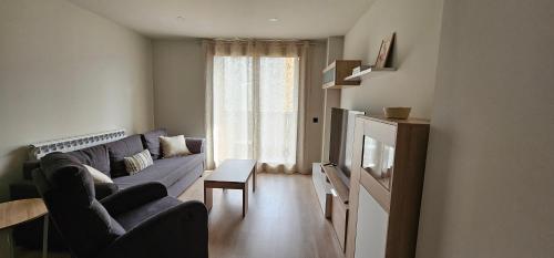 a living room with a couch and a table at Mirador de Cerler in Benasque