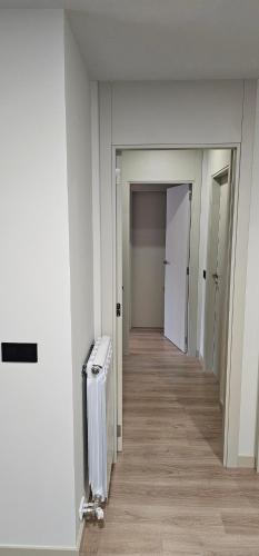 an empty room with a hallway with a radiator at Mirador de Cerler in Benasque