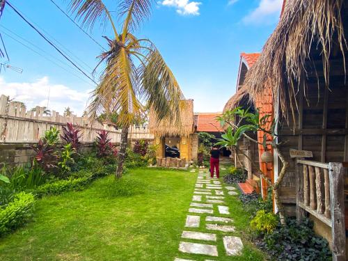 a person standing in the yard of a house at Umah Suta Sari in Dalung