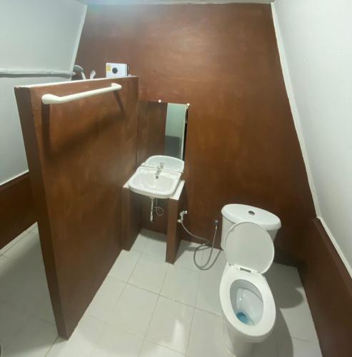 a bathroom with a toilet and a sink at Khlongsaeng farmstay in Ban Ta Khun