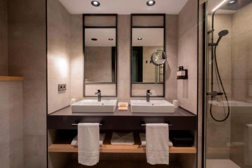 a bathroom with two sinks and a shower at Hotel Piolets Soldeu Centre in Soldeu