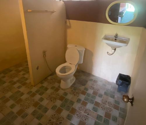 a bathroom with a toilet and a sink at คลองแสงฟาร์มสเตย์ in Ban Ta Khun
