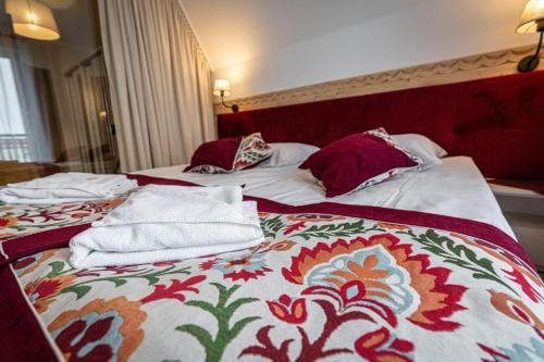 two beds with towels on them in a hotel room at Pensjonat Dawidek in Zakopane