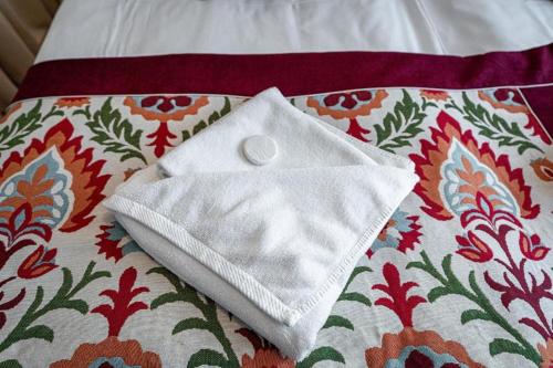 a white napkin sitting on top of a bed at Pensjonat Dawidek in Zakopane